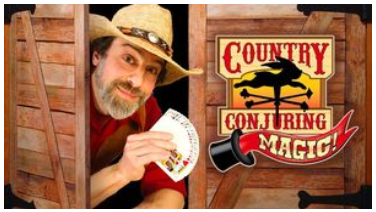 Erik Hershey is wearing a cowboy hat and holding playing cards in one hand. He peeks out from a saloon and his magical logo is next to him.