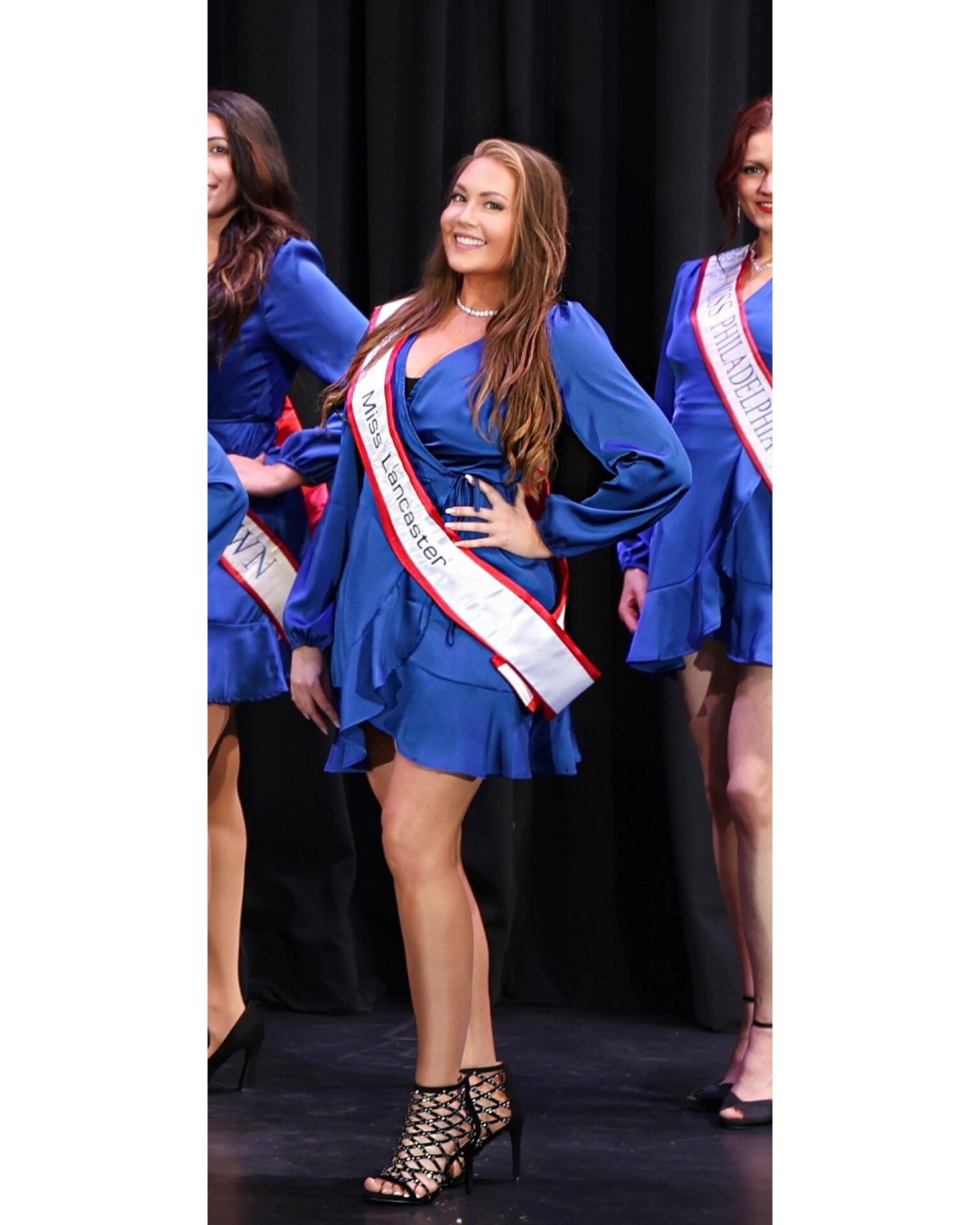 Photograph of Miss Lancaster in a blue dress with a white sash.